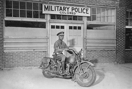 A black Military Policeman (MP) in front of a "colored" MP entrance in Georgia (1942)