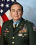 A head and upper body portrait of a middle-aged, cleanshaven man with dark hair, wearing a formal military uniform with many medals on the front. A five-pointed gold star hangs from a blue ribbon around his neck.