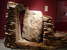 Stone door in a megalithic dolmen with lateral tenons