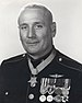 A black and white image of Howard wearing his dress blue uniform with medals and no hat. His Medal of honor can be seen around his neck and he is turned slightly to the left.