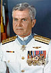 A color image of showing the head and upper torso of Stockdale wearing his military dress uniform with medals. His Medal of Honor can be seen around his neck.