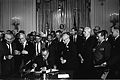 Lyndon Johnson (1964) signs the Civil Rights Act of 1964, with Martin Luther King behind him