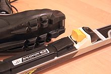 The SNS profile cross-country binding has a metal axle that locks into the binding.