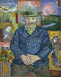Portrait of a man of a bearded man facing forward, holding his own hands in his lap; wearing a hat, blue coat, beige collared shirt and brown pants; sitting in front of a background with various tiles of far eastern and nature themed art.