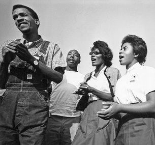 Four young marchers singing